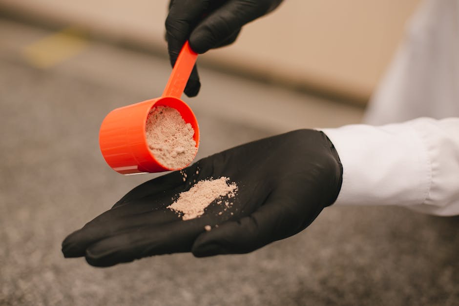 Person gently scooping clumping cat litter from a litter box