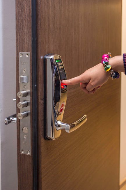 Person using a smartphone to manage a smart door lock and camera alerts at home