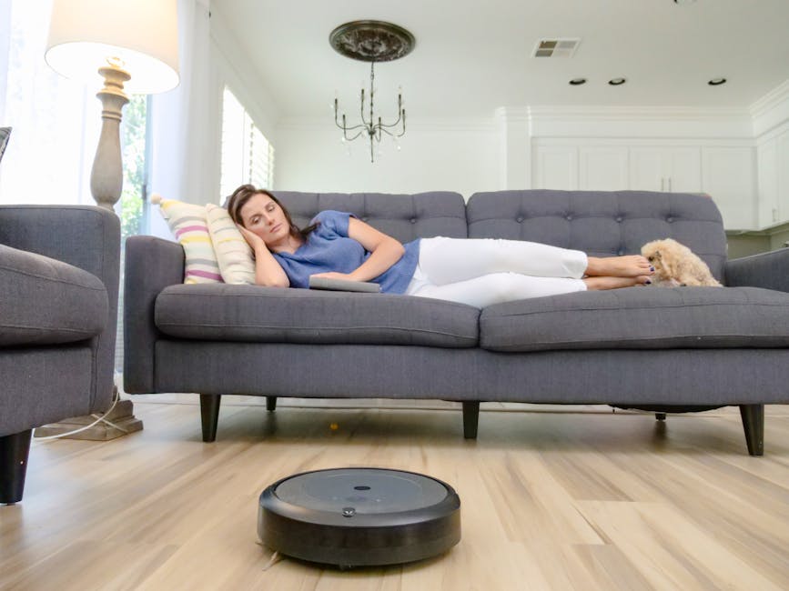 Cat or dog inspecting a robot vacuum on the floor in a modern living room