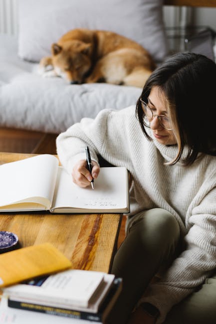 Pet parent writing a trigger log while observing a dog at home
