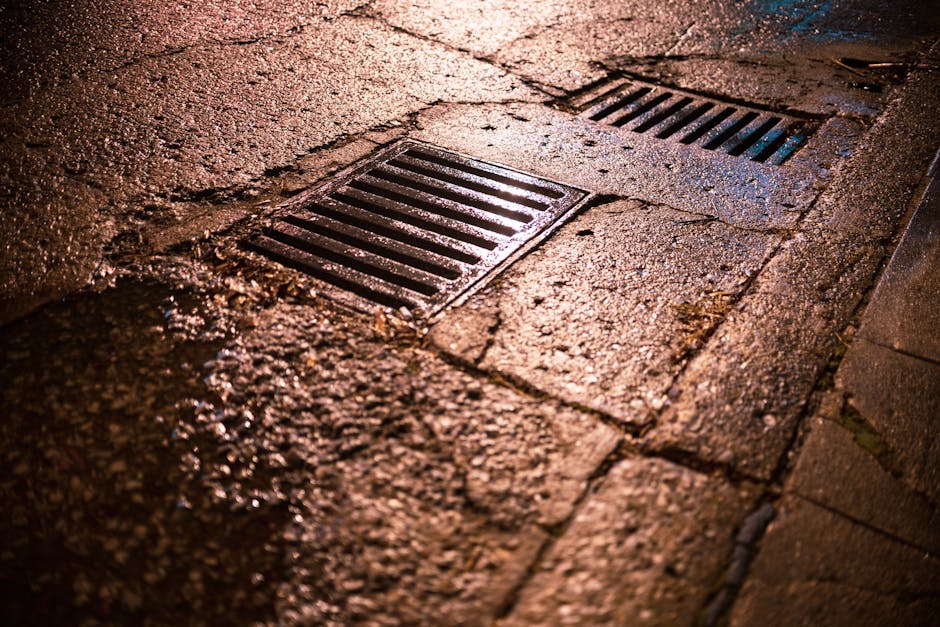 Water running off a sloped yard near a home, showing drainage control