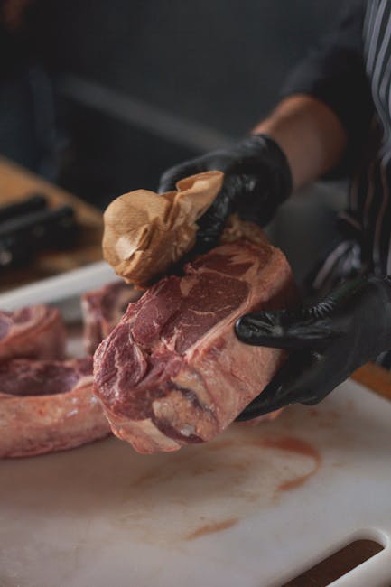 Person washing hands and disinfecting kitchen surfaces after handling raw pet food