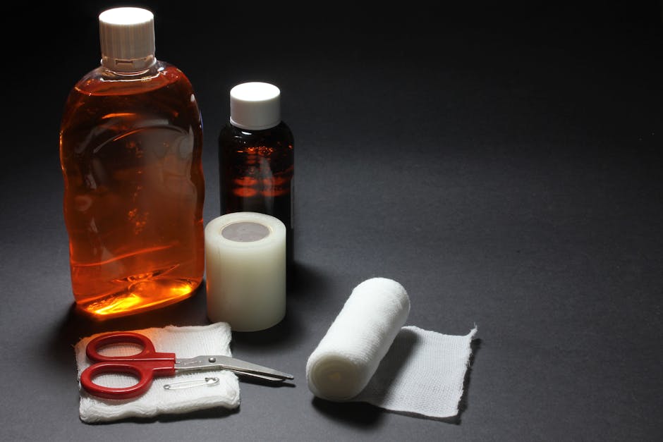 Dog first aid kit items like gauze, bandage wrap, saline, and thermometer